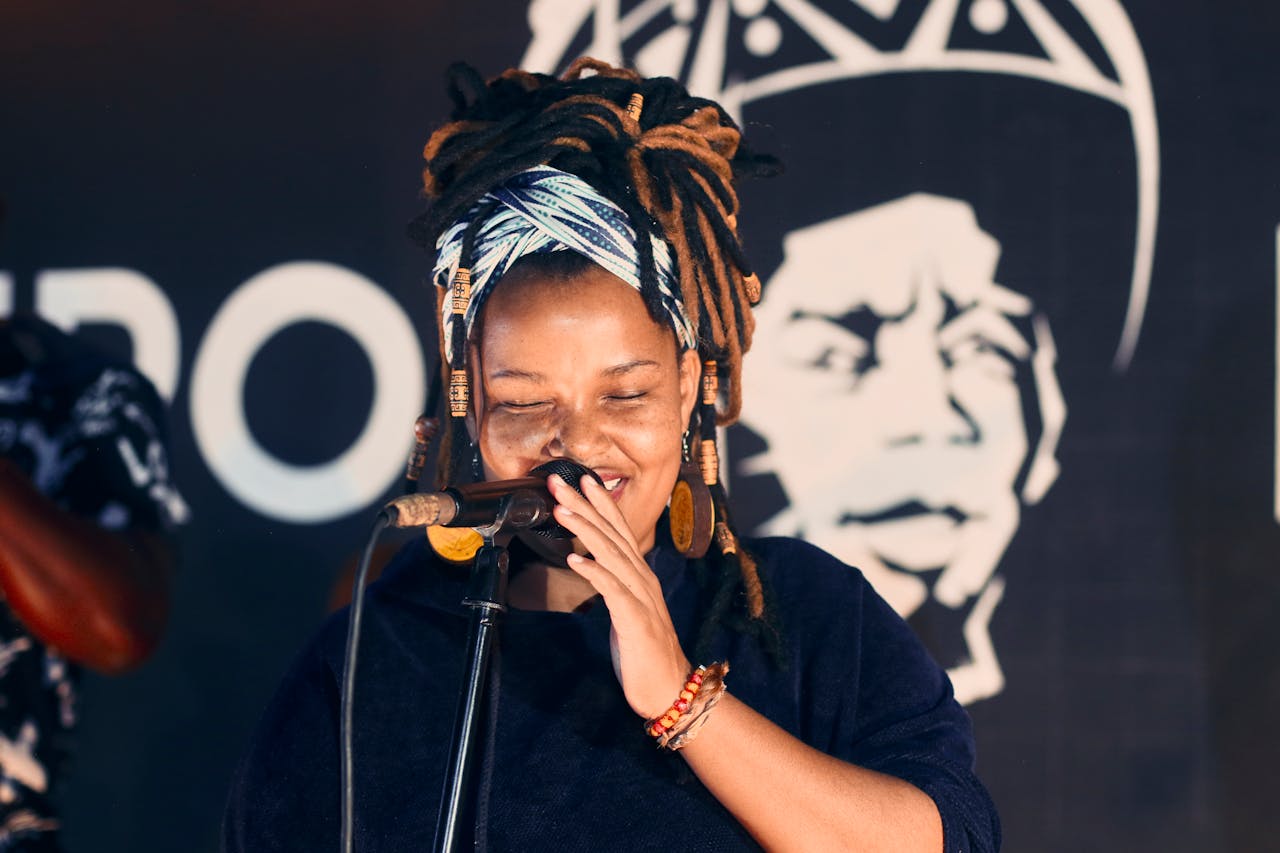 Vibrant performance by a female singer in Johannesburg, showcasing cultural style and joyous expression.